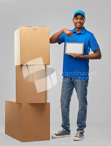 Image of indian delivery man with tablet pc and boxes