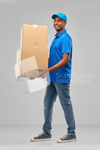 Image of happy indian delivery man with parcel boxes