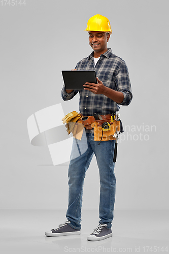 Image of happy indian builder in helmet with tablet pc