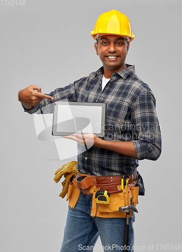 Image of happy indian builder in helmet with tablet pc
