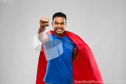 Image of indian man in superhero cape flying over grey