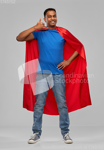 Image of indian man in superhero cape making call gesture