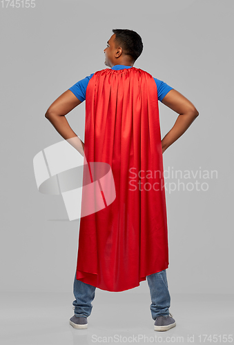 Image of happy smiling indian man in red superhero cape