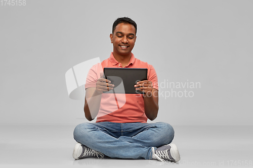 Image of happy indian man with tablet pc