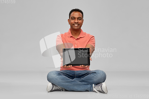 Image of happy indian man with tablet pc