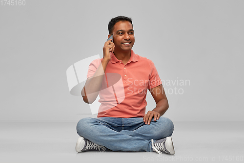 Image of happy indian man calling on smartphone