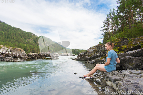 Image of Woman resting at river