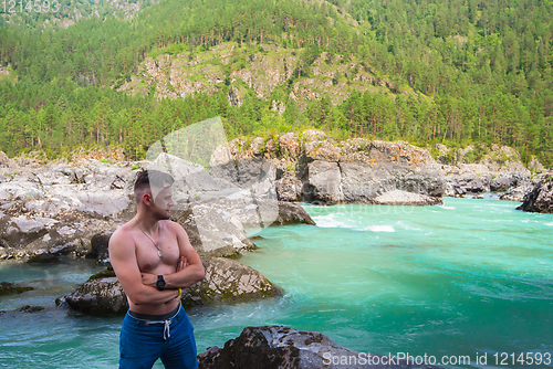 Image of Man resting at river