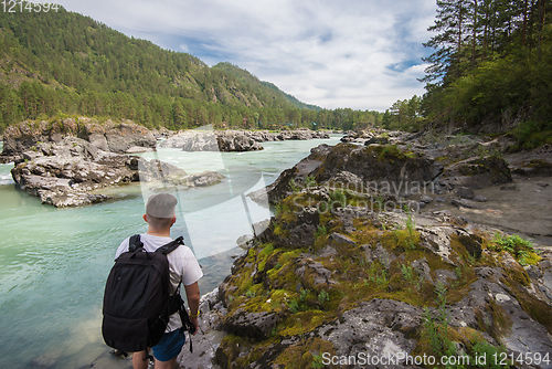 Image of Man resting at river