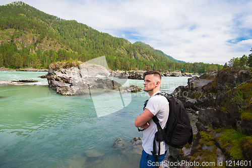Image of Man resting at river