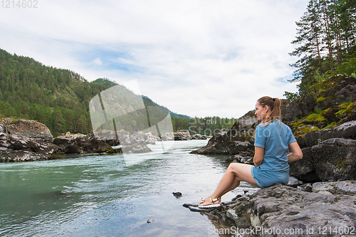 Image of Woman resting at river