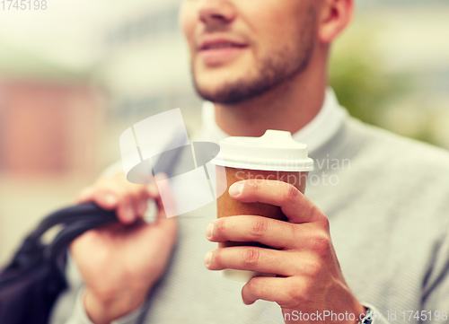 Image of close up of man with coffee cup on street