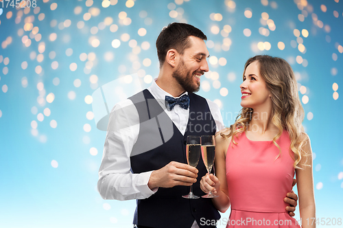 Image of happy couple with champagne glasses toasting