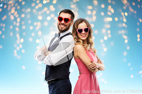 Image of happy couple in heart-shaped sunglasses