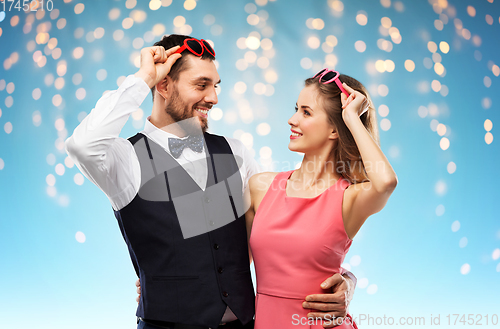 Image of happy couple in heart-shaped sunglasses