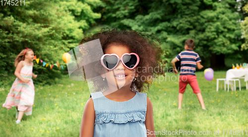 Image of little african girl in sunglasses at summer party