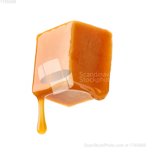 Image of caramel sauce flowing on flying caramel candy