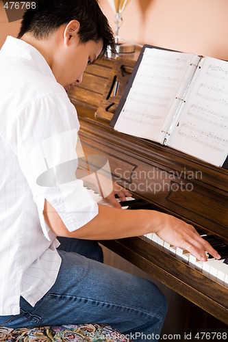 Image of Asian playing piano