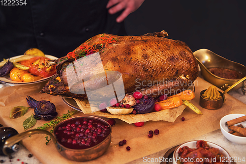 Image of Roasted goose with herbs berries and vegetables
