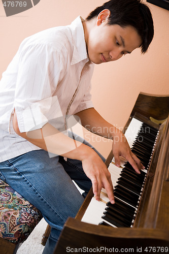 Image of Asian playing piano