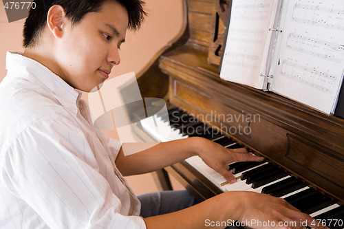 Image of Asian playing piano