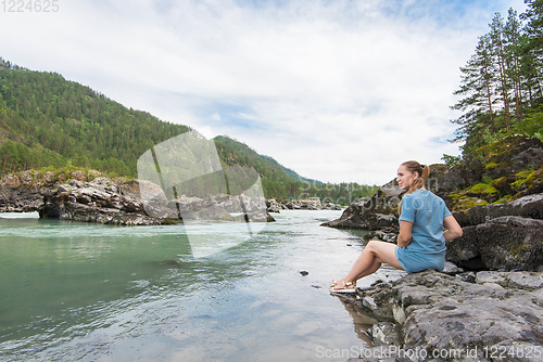 Image of Woman resting at river