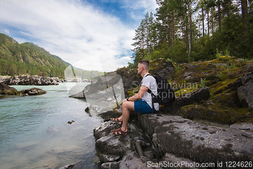 Image of Woman resting at river