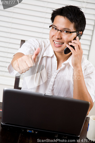 Image of Asian entrepreneur thumbs up