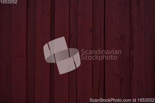 Image of tradidional wooden wall of a red house in Norway