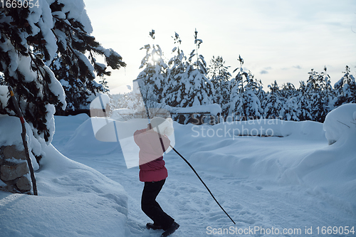 Image of girl throwing fresh snow at beautiful sunny winter day