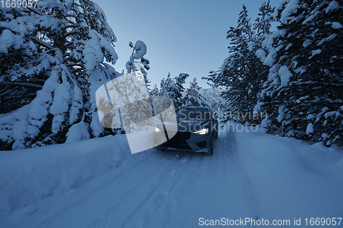 Image of offroad suv car on icy winter north road