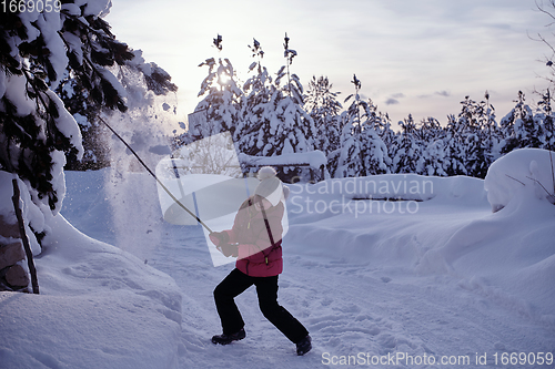 Image of girl throwing fresh snow at beautiful sunny winter day