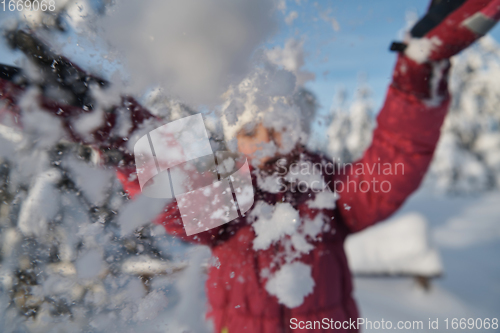 Image of girl throwing fresh snow at beautiful sunny winter day