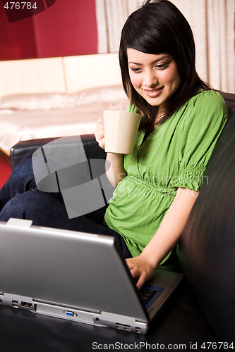 Image of Asian girl with laptop and coffee cup