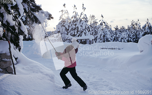 Image of girl throwing fresh snow at beautiful sunny winter day