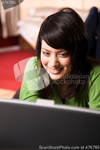 Image of Asian girl relaxing laptop
