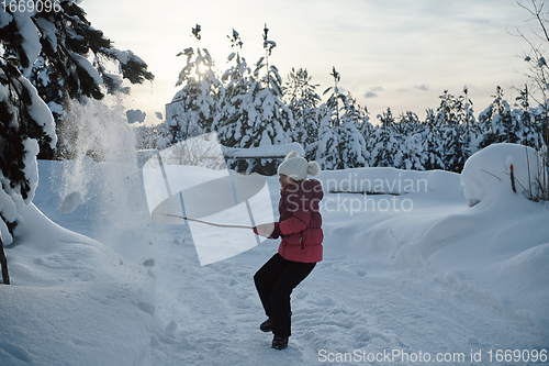 Image of girl throwing fresh snow at beautiful sunny winter day