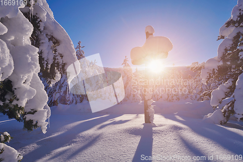 Image of wooden cross covered with fresh snow at beautiful fresh winter morning