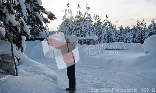Image of girl throwing fresh snow at beautiful sunny winter day