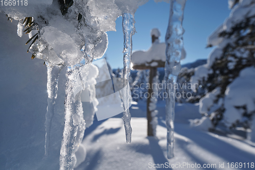 Image of wooden cross covered with fresh snow at beautiful fresh winter morning