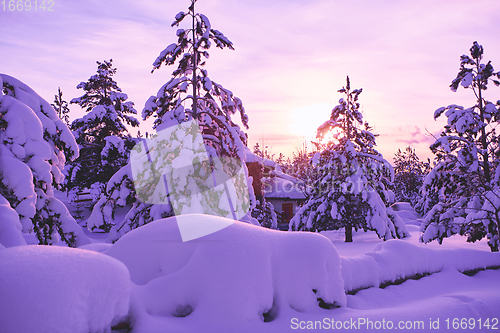 Image of winter sunrise with fresh snow covered forest and mountains