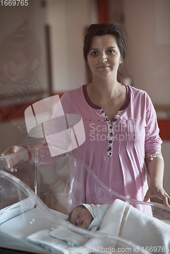 Image of newborn baby and mother in hospital