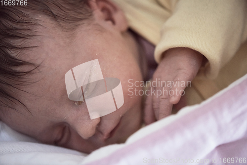 Image of newborn baby sleeping in bed at hospital