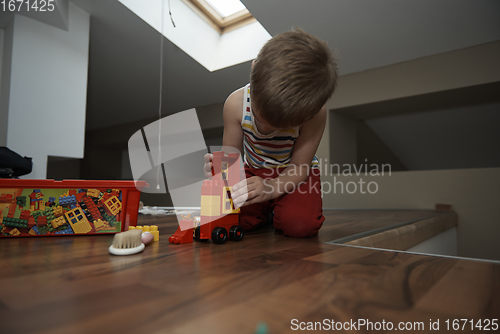 Image of Little boy child playing with creative toys