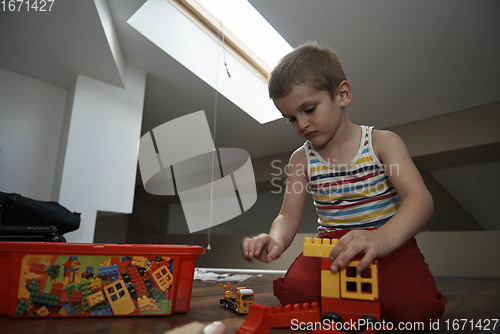 Image of Little boy child playing with creative toys