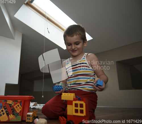 Image of Little boy child playing with creative toys