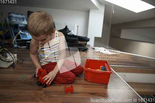 Image of Little boy child playing with creative toys