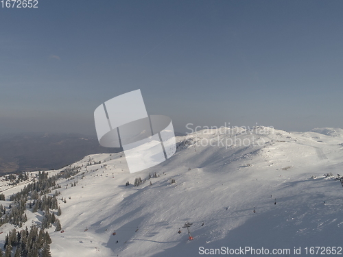 Image of sunny winter day with fresh snow in ski resort