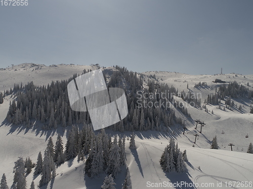 Image of sunny winter day with fresh snow in ski resort