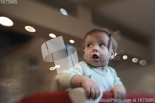 Image of cute little baby playing in mobile bed